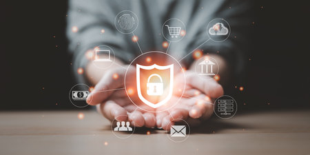 In a woman's hand is a shield icon, a symbol of security within the Internet world. Cybersecurity and privacy concepts to protect business data, technology networks, payment online, shopping,の写真素材