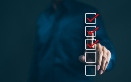 Businessman interacting with a virtual checklist with red check marks. A business professional is completing a checklist. tick correct sign mark in the checkbox, Checkmark, Filling out digital form,の写真素材