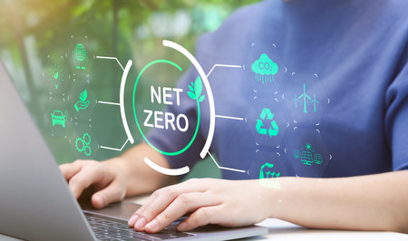 Woman use laptop with environmental carbon reduction icon or net zero technology. carbon neutrality. Carbon footprint, CO2 emissions, Sustainable energy, Global warming, Greenhouse gas, Climate changeの写真素材