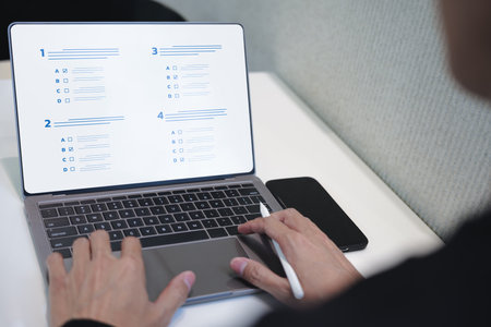 Businessman evaluating with checkbox on online laptop. assessment survey online, choose correct answer in test, questions test, online exam, quiz knowledge, filling out a survey form. Checklist onlineの写真素材