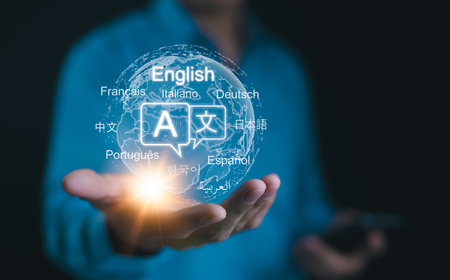Multilingual Language Translation Technology Concept. A person holding holographic globe with speech bubbles and various languages, represents global language translate and multilingual communication.の写真素材