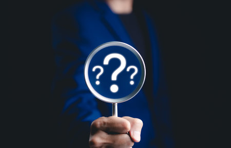 Question mark, Problem solving and analysis concept. Businessman holds magnifying glass focused on question mark, analysis, problem solving, identifying cause of issues during work process, solution,の写真素材