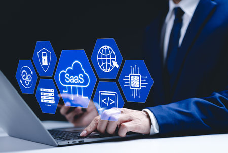 SaaS Concept, Software as a Service, Businessman types on laptop with icons representing aspects of...