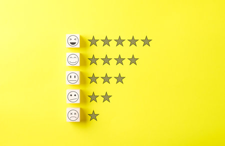 Customer satisfaction feedback and rating concept. Wooden blocks with facial expressions aligned...