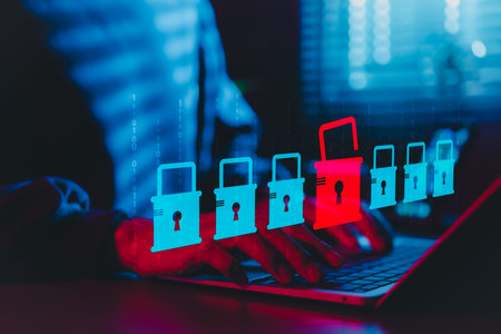Cybersecurity and Data Breach Risk Concept. A person using laptop with digital padlock icons, red...