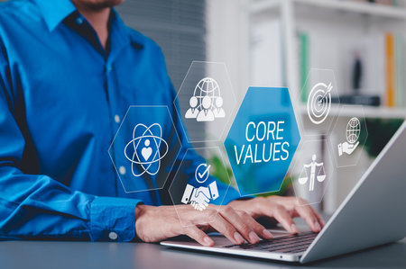Core Values and Corporate Ethics Concept. Businessman using laptop with icons representing core...
