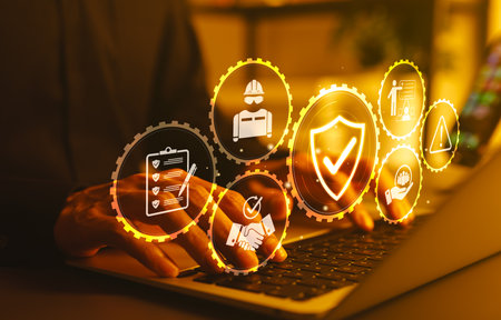 Work Safety and Compliance Concept. hands typing on a laptop with icons work safety, compliance, risk management, operational efficiency, health protocols, workplace regulatory, and safety standards.の写真素材