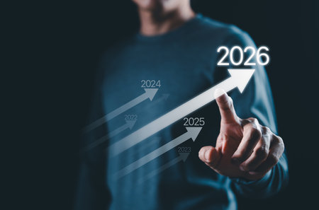 Business growth strategy towards 2026 Concept. Person points at arrow 2026, with progress arrows...