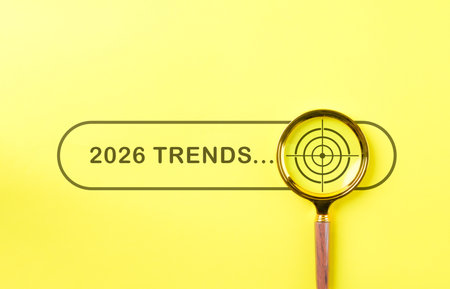 2026 Trends Search Concept. Yellow background with search 2026 Trends, magnifying glass focusing on...