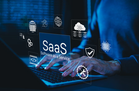 SaaS Software as a Service Digital Cloud Technology. Hands typing on laptop with SaaS icons representing cloud computing, data storage, software integration, security, and service based applications.の写真素材