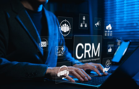 CRM system and customer relationship management technology. Using laptop with digital CRM icons representing customer relationship management, marketing automation, analytics, client engagement tools,の写真素材