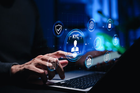 Businessman using laptop with digital KYC interface and identity verification icons. Concept of cybersecurity, online banking, secure authentication, and digital customer onboarding in fintech systemsの写真素材
