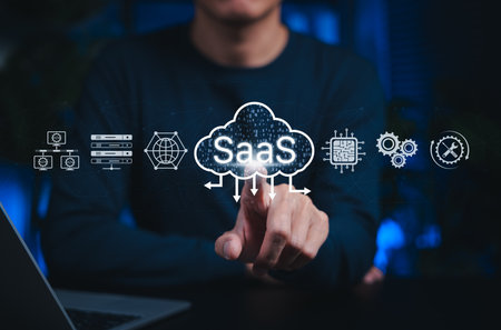 SaaS cloud computing and software service technology. Person interacts with SaaS cloud icons, represent Software as a Service, cloud infrastructure, data processing digital platform-based solutionsの写真素材