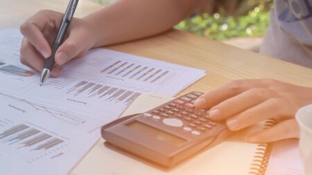 Closeup of hand man using calculator and calculate about cost at home office.の写真素材
