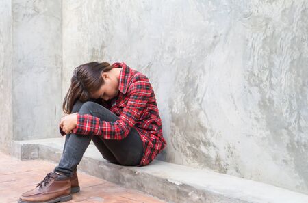 sad woman hug her kneeの写真素材