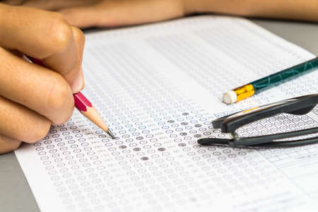 Student filling answers , drawing selected choice on answer sheetsの写真素材