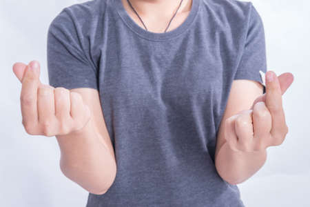 Woman hands making small heart on a white isolated backgroundの写真素材