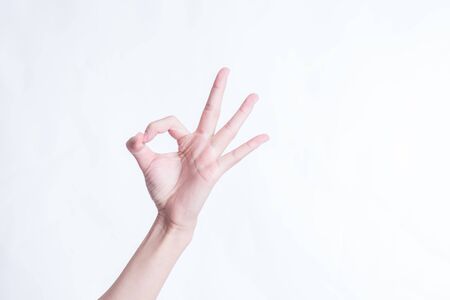 Hand OK sign isolated on white backgroundの写真素材