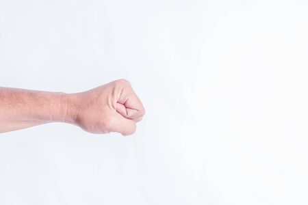 Closeup of right male hand raised up clenched fistの写真素材