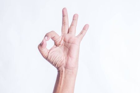 Hand OK sign isolated on white backgroundの写真素材