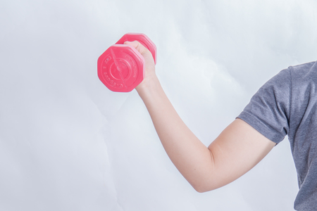 Healthy Asian business woman with dumbbells isolated on white background.の写真素材
