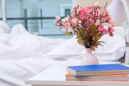 Artificial Flower Vase on Wooden Table in Style Bedroomの写真素材