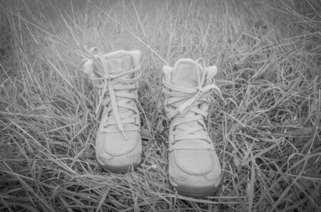 A pair of brown boots on a grassy background.の写真素材