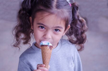 Ice cream in hands cute little girlの写真素材