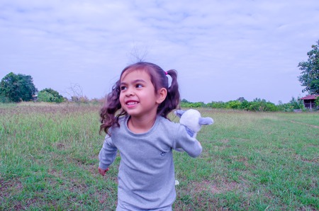 Cute little kid running in the garden.の写真素材