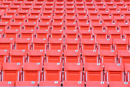 Many orange chairs in football stadium.の写真素材