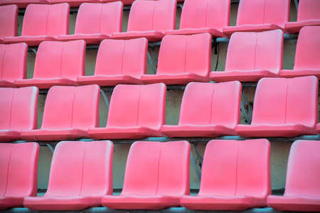 Many orange chairs in football stadium.の写真素材