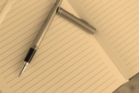 notebook and pen on tableの写真素材