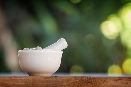 Alternative medicine herb , mortar, laboratory glassware, on a wooden background.