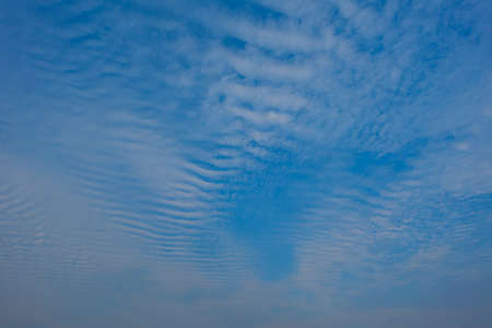 Blue sky with white clouds, (Cirrocumulus clouds)  in blue sky on sunny peaceful day.