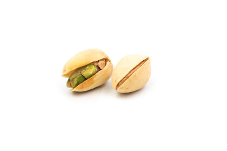 Close-up of tasty pistachios, isolated on the white background.の写真素材