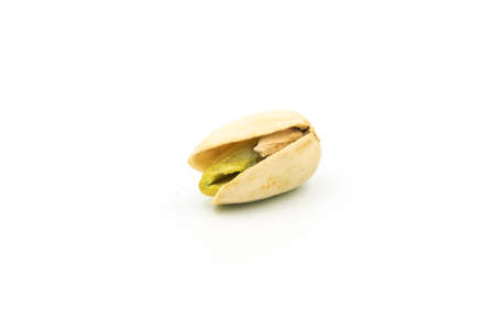 Close-up of tasty pistachios, isolated on the white background.の写真素材