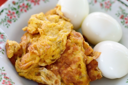 Omelettes and eggs cooked in a white dish の写真素材