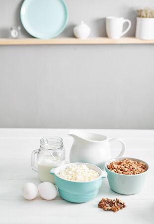 Clean eating healthy cooking ingredients. Food frame. Superfoods concept. Fitness Breakfast.Healthy eating and food, dieting, vegetarian kitchen, Cottage cheese and oatmeal with milk on table.の写真素材