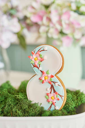 Gingerbreads for March 8 in the bright kitchen with flowersの写真素材