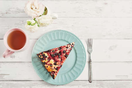 Homemade flavored pie with currants and gooseberries. Delicious tart on white wooden background, top view. Healthy eating and food. Summer fruit dessert. Bake fruit cake. Delicious homemade pie.の写真素材