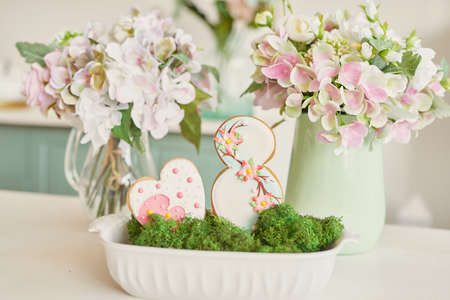 Gingerbreads for March 8 in the bright kitchen with flowersの写真素材