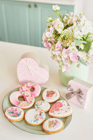 Gingerbreads for March 8 in the bright kitchen with flowersの写真素材