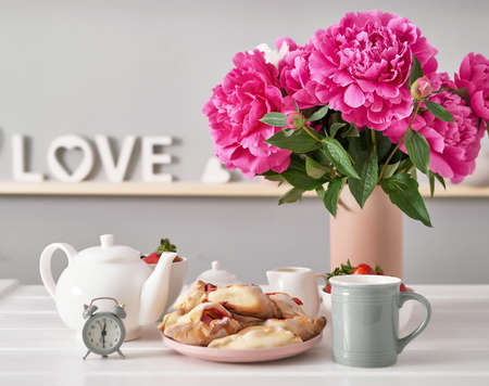 Strawberries and peonies flowers. Romantic breakfast at hotel. Mother's Day Greeting Card. Tea set and buns with strawberries. Cozy morning. Valentine's Day. Sweet dessert. Good morning!の写真素材