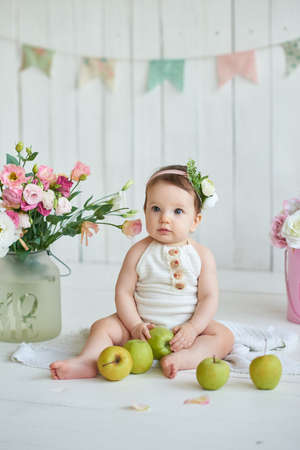 Sweet funny baby in hat with flowers. Easter greeting card, copyspace for your text. Poster for...