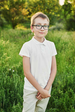 Summer holidays, happy childhood. Children Protection Day. ? hild boy walks in park. Child in field at sunset. Walk in field and forest, vacation in village. Summer parkの写真素材