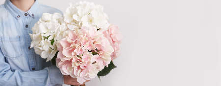 Child boy with bouquet of flowers. Mother's Day Greeting Card. Happy mothers day frame background. Spring card template. Happy Birthday or Valentine. Women's Day. Copy space. Child gives bouquet.の写真素材