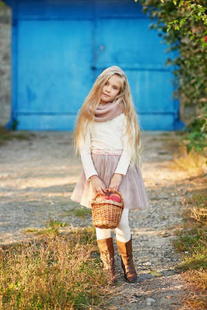 Happy little child, baby girl playing in autumn on nature walk outdoors. Autumn background. Family walk in park. School time. childhood happiness. Fall season.の写真素材