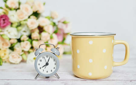 Cozy morning. Mothers day greeting flower card. Bouquet of flowers and alarm clock. Good morning....