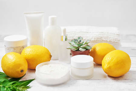 Natural organic homemade cosmetics with lemon. Skin care. Spa salon and treatments. Beautician background. Clay, lemon, beauty products, tropical summer concept. Flat lay, copy space.の写真素材