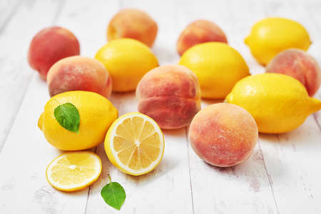 Fruit lemons and peaches on white background. Summer postcard. Hello summer! Harvesting. Healthy food and nutrition. Fruit background. Cozy breakfast. Natural organic products. Vitaminsの写真素材